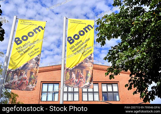 10 July 2020, Saxony, Zwickau: Flags with the logo of the 4th Saxon State Exhibition wave in front of the Audi building. The show with the motto ""Boom