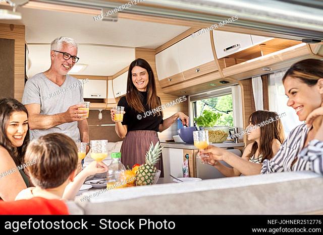 Family having meal in camper van