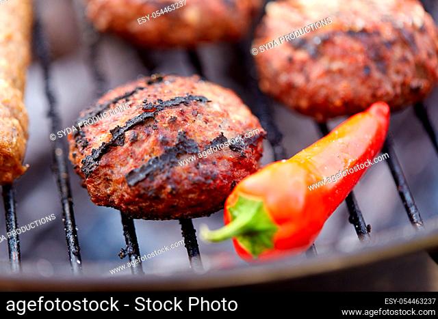 burger meat cutlets and pepper roasting on grill