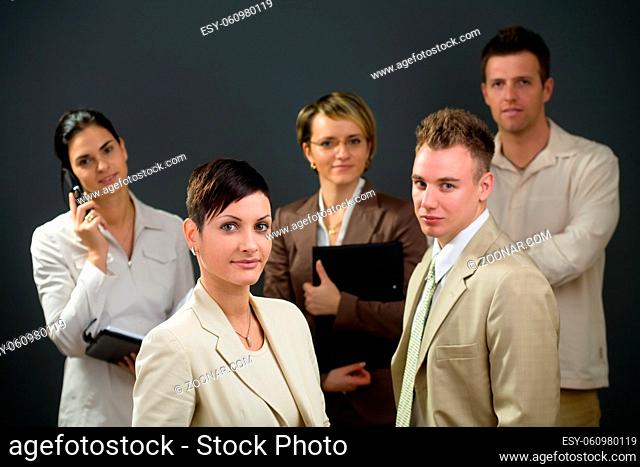 Businesswoman standing in front of his smiling team