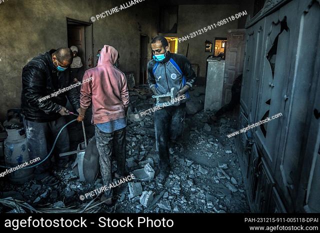 15 December 2023, Palestinian Territories, Rafah: Palestinians inspect damages after an Israeli air strike on a house belonging to the Al-Arja family in the...
