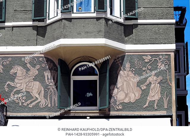 Colourful townhouses in the pedestrianised zone of the historic old town of Bozen in South Tyrol - Historic paintings and carvings are to be seen on the facade...