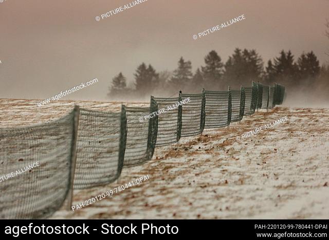 20 January 2022, Saxony-Anhalt, Elbingerode: Snow fences stand on a meadow in the Upper Harz Mountains. Visibility obstructions due to snow drifts were on the...