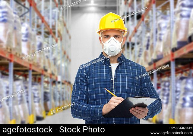 male worker in mask with clipboard at warehouse