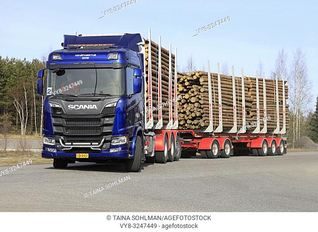LIETO, FINLAND - APRIL 12, 2018: Blue Scania R730 logging truck makes left turn on test drive during Scania Tour 2018 in Turku