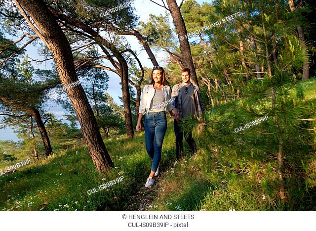Young couple strolling in coastal forest, Split, Dalmatia, Croatia