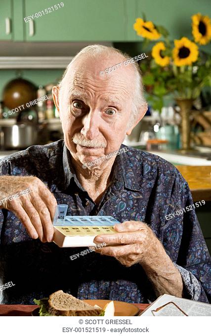 Elder Man with a Pill Case