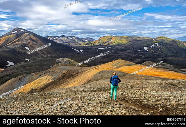 Hiker on the Laugavegur trekking trail, Laugavegur trekking trail, Dramatic volcanic landscape, Colourful erosion landscape with mountains, Lava field