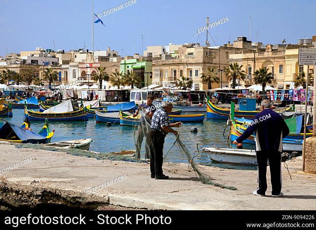 Fischer check your nets in the harbor of Marsaxlokk, Malta