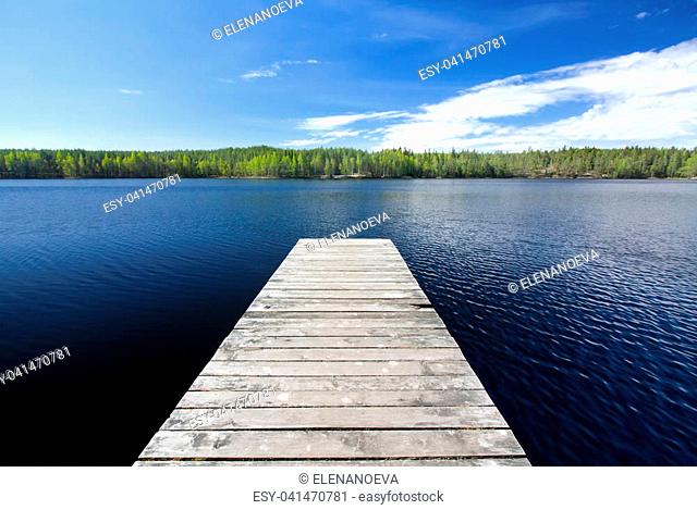 Wooden pier on beautiful lake in the national park Repovesi, Finland, South Karelia