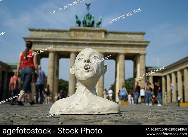 25 July 2021, Berlin: To mark the International Day of Sea Rescue, human rights activists have placed a clay figure in the political art action...