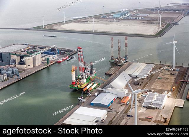 Dutch harbor Eemshaven with wind turbines and off shore construction platforms