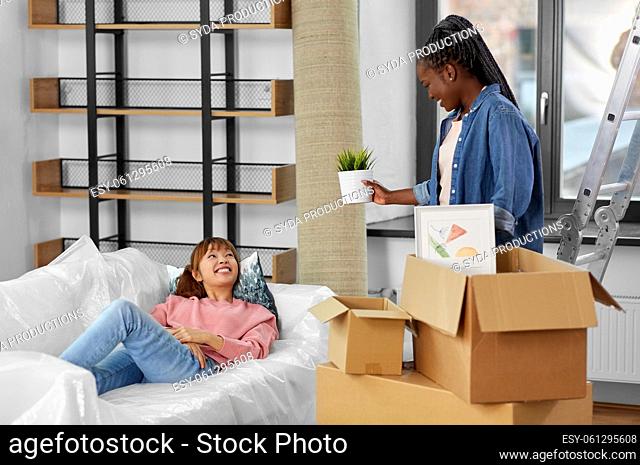 women unpacking boxes and moving to new home