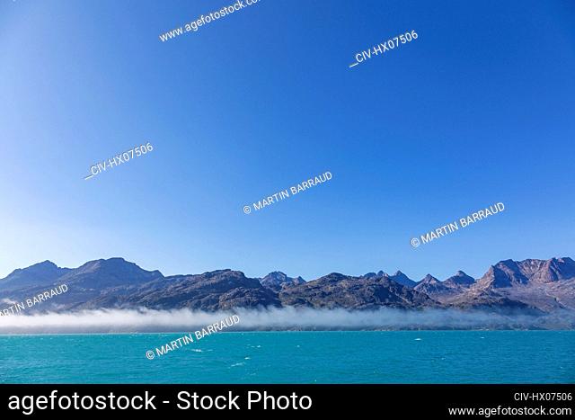 Blue sky over majestic mountain landscape and ocean Greenland