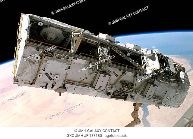 Backdropped by the blackness of space and Earth's horizon, the S0 (S-Zero) Truss is moved from the Space Shuttle Atlantis' cargo bay