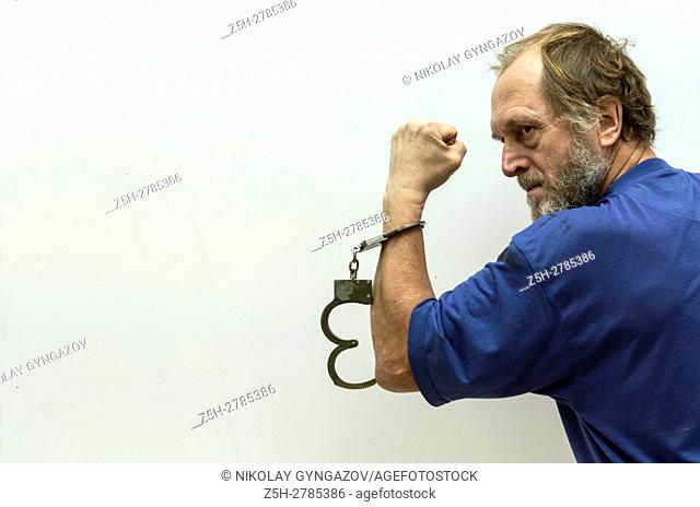 Elderly man handcuffed