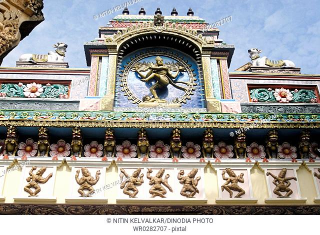 Nataraja lord Shiva performing Tandava cosmic dance colourfully painted stucco work on facade of Nataraja Hall , Thanjavur palace , Thanjavur , Tamil Nadu