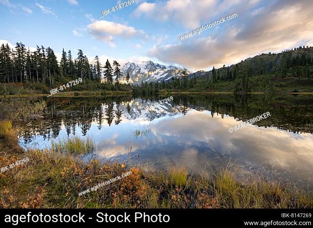 Mt. Shuksan glacier with snow reflecting in Picture Lake, forested mountain landscape in autumn, at sunset, Mt. Baker-Snoqualmie National Forest, Washington