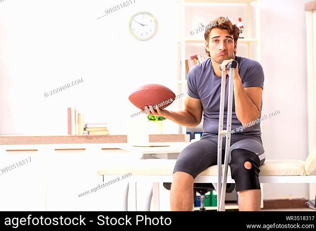 Handsome american footbal player visiting female doctor traumatologist