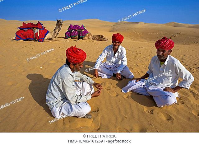 India, Rajasthan state, Jaisalmer, Rajput nomads with their camel caravan in the Thar desert