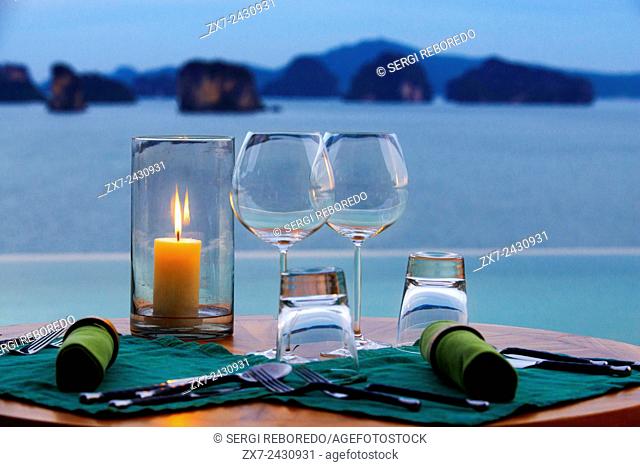 Six Senses Resort, Koh Yao Noi, Phang Nga Bay, Thailand, Asia. Romantic table in the restaurant near the swimming pool called The Hilltop Reserve in front of...