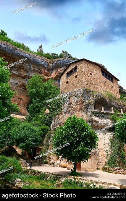 Stone house over a big rock close of a cliff at Orbaneja del Castillo, Burgos, Spain, Europe