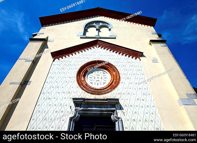 crugnola italy  church varese the old door entrance and abstracr mosaic sunny daY rose window