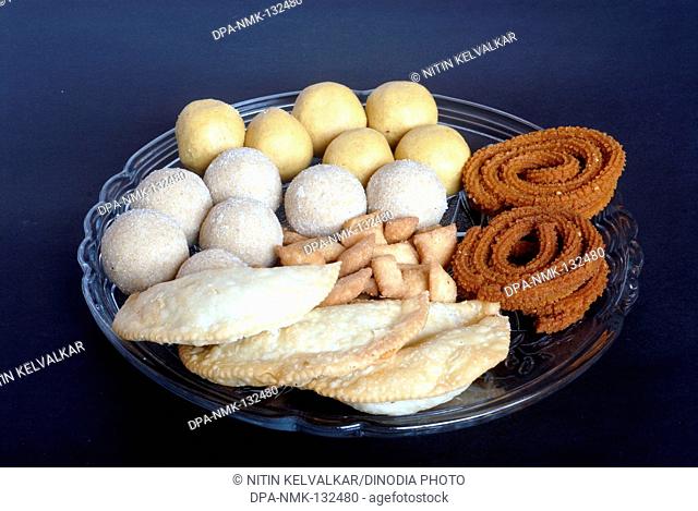 Besan ladoo ; Rava ladoo ; Karanji ; Shankarpali and Bhajani Chakli ; Homemade Maharashtrian Food made for Diwali Festival ; Mumbai Bombay ; Maharashtra ; India