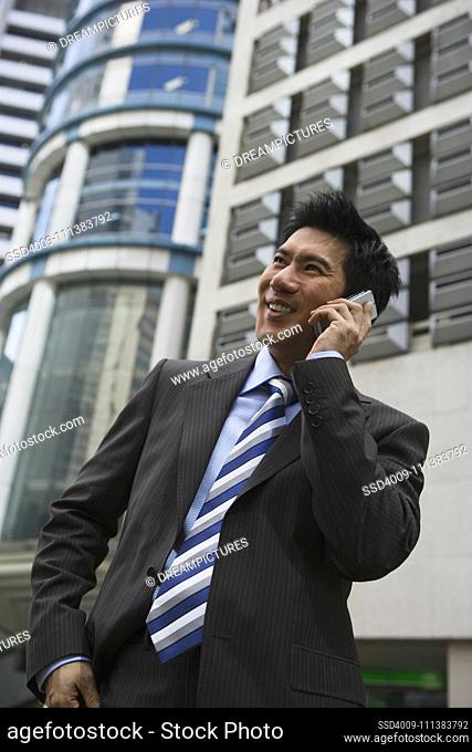 Chinese businessman talking on cell phone