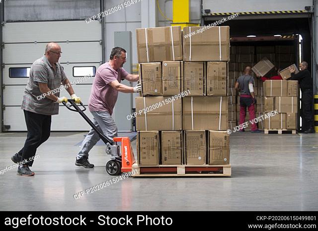 Workers unload boxes with medical protective equipment in storage facility in Opocinek, near Pardubice, Czech Republic, on June 15, 2020