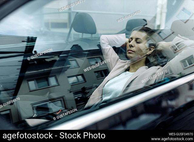 Businesswoman relaxing in car
