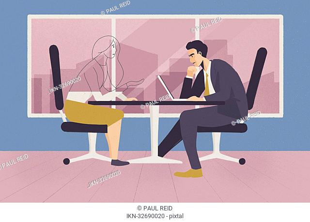 Businessman with laptop and transparent businesswoman sitting at desk