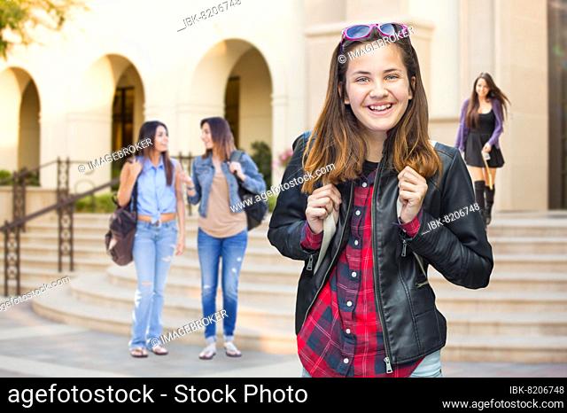 mixed-race young female student walking on campus