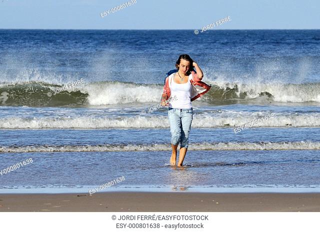 Girl walking at beach, Lossiemouth, Moray, Scotland, United Kingdom, Europe