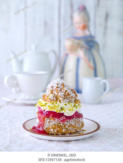 A profiterole filled with rhubarb compote and pistachio cream
