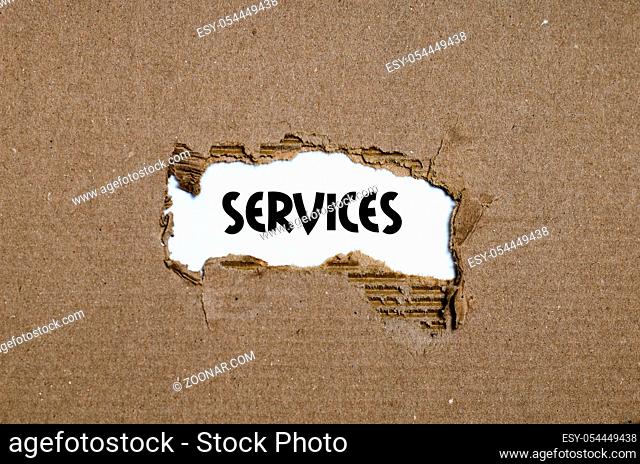 The word services appearing behind torn paper