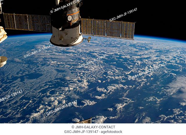 One of the Expedition 36 crew members aboard the International Space Station photographed this image of a docked Russian Progress cargo spacecraft backdropped...