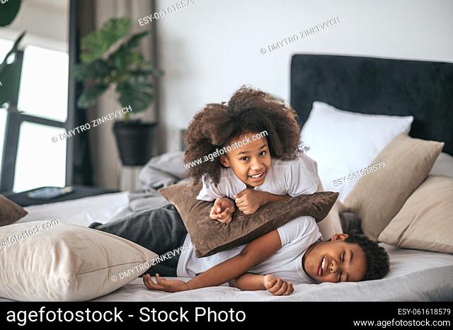 Playing. Two kids playing on the bed in the bedroom
