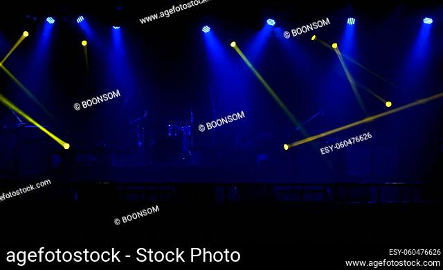Blue and yellow stage spotlights with smoke. Floodlights of concert scene