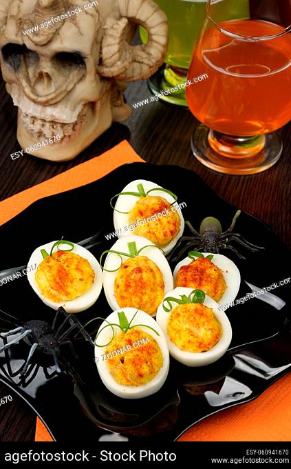 Stuffed eggs in the form of a pumpkin on the holiday table in honor of Halloween