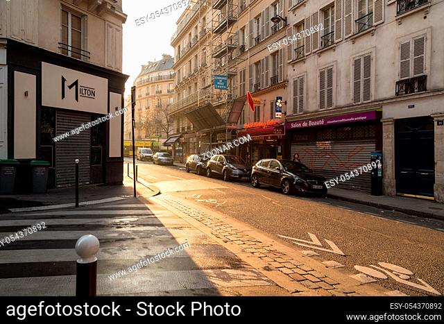 Paris, France, March 27, 2017: View on narrow cobbled street among traditional parisian buildings in Paris, France