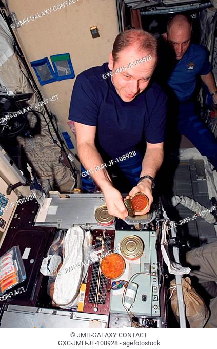 Cosmonaut Oleg V. Kotov, Expedition 15 flight engineer representing Russia's Federal Space Agency, prepares to eat a meal at the galley during a farewell...