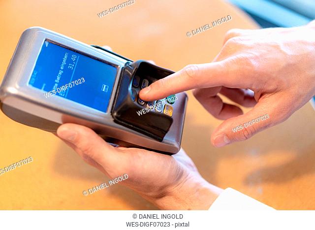 Man using credit card reader, close-up