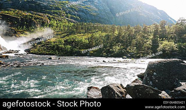 Kinsarvik, Hordaland, Norway. Waterfall Nykkjesoyfossen In Hardangervidda Mountain Plateau. Spring Sunny Day. Height Of 49 m