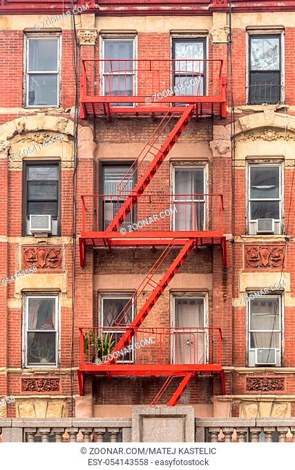 Traditional red fire escape of an apartment building in New York city