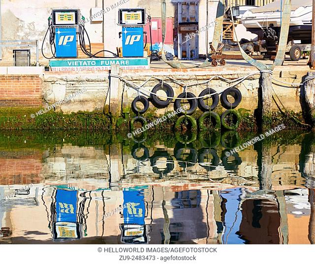 Canalside scene with fuel pumps and reflections, Chioggia, Venetian Lagoon, Veneto, Italy, Europe