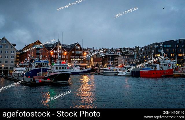 Tromso, Norway - December 2018 : Boats in port and harbour in Tromsoysundet strait in Tromso in winter