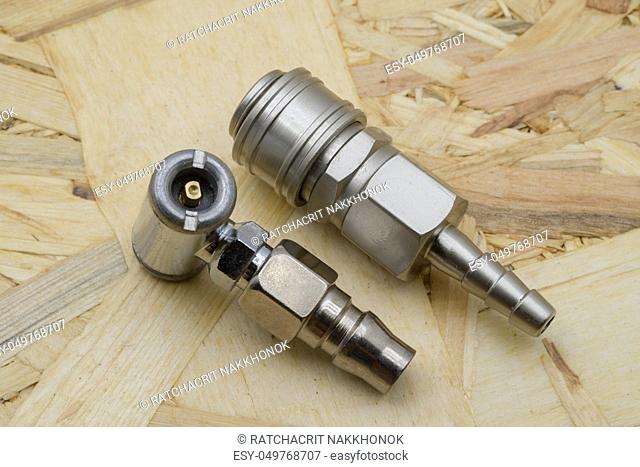 Air coupling connector, Pneumatic fitting on wood background
