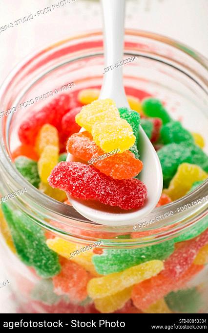 Sour Sweets (jelly sweets, USA) in jar with spoon