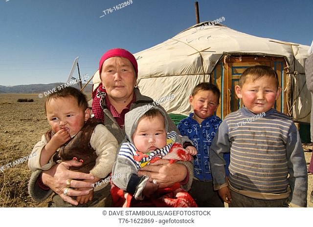 Kazakh eagle hunter's family in front of their ger yurt in the Altai Region of Bayan-Ölgii in Western Mongolia